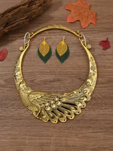 Closeup view of vintage gold peacock collar necklace and leaf drop earrings set for women.