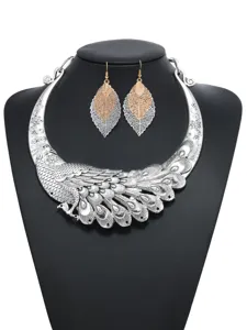 Detailed close-up shot of vintage silver peacock choker necklace and leaf earrings jewelry set.