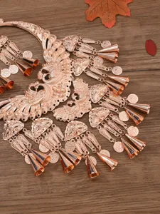 Ethnic peacock collar necklace detail, rose gold alloy jewelry set, close-up shot.