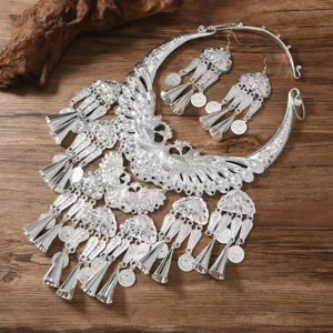 Detailed view of traditional ethnic style Miao silver peacock necklace and matching earrings set.