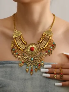 Vintage ethnic gold statement necklace and earrings set with red and turquoise stone pendants.