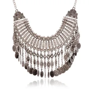 Detailed view of a vintage silver alloy bib necklace with ornate coin fringe and ethnic style.