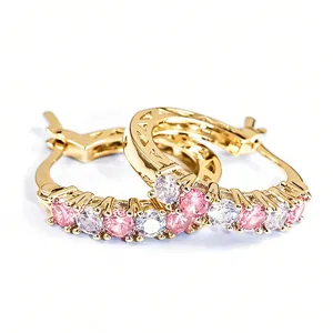 Detailed view of French style gold plated hoop earrings with pink and white cubic zirconia.