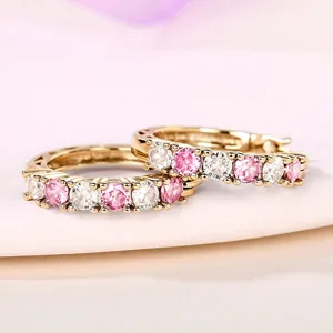 Detailed view of gold hoop earrings featuring alternating pink and white cubic zirconia.