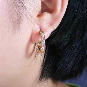 Detail shot of French style U-shaped hoop earrings featuring full paved pink and white zirconia.