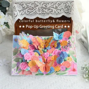 Carte de vœux pop-up 3D faite à la main avec fleurs et papillons colorés pour cadeaux.
