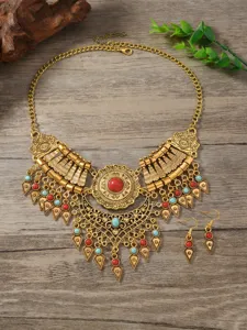 Close-up detail of vintage ethnic style alloy statement necklace and earrings set.