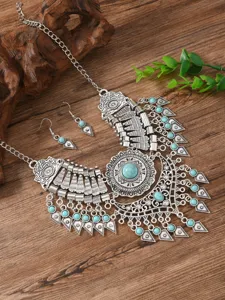 Boho vintage style necklace and earrings detail shot with turquoise stone and silver alloy.