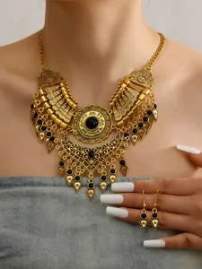 Detailed view of vintage ethnic gold-tone bib necklace and matching earrings set.