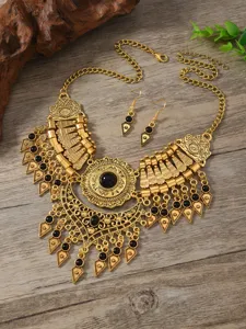 Vintage ethnic style gold-toned alloy necklace and earrings set with black stones.
