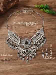 Retro ethnic style silver necklace and earrings set detail view with black stone decor.