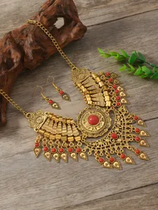 Vintage ethnic gold-tone statement bib necklace and matching drop earrings detail view.