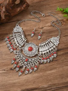 Vintage ethnic style silver metal red stone statement necklace and earrings jewelry set details.