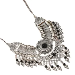 Vintage ethnic statement bib necklace with black beads and intricate silver metal charms decor.