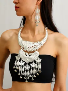 Close-up detail of ethnic minority silver choker necklace and matching tassel earrings.