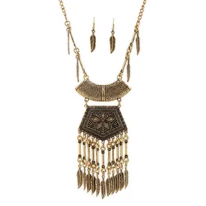 Vintage bohemian gold feather statement necklace and matching earrings jewelry set for women.