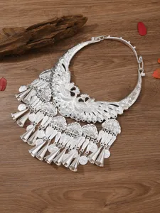 Exquisite Miao ethnic silver collar necklace detail, featuring intricate peacock and bell pendants.