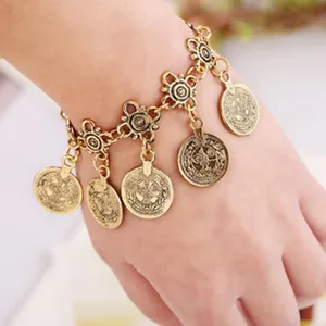 Vintage gold coin charm bracelet for women, intricate carved links, bohemian wrist jewelry.