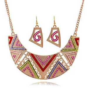 Bohemian geometric statement bib necklace and earrings set with colorful beads in gold tone.