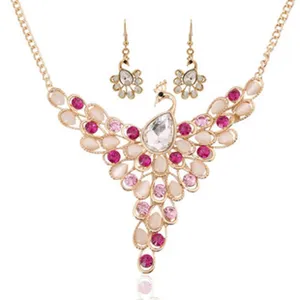 Peacock pendant necklace and earrings jewelry set, gold-tone alloy with dazzling crystals.