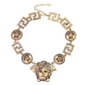 Vintage gold statement necklace featuring geometric links and coin medallion pendant for women.