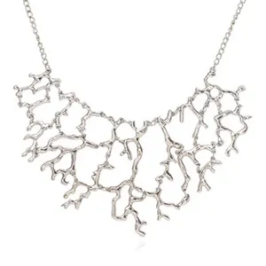Silver abstract branch statement necklace for women, trendy avant-garde fashion jewelry accessory.