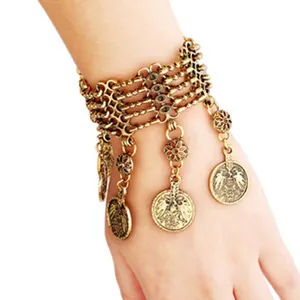 Detailed view of the antique bronze multi-strand coin tassel bracelet fashion accessory item.