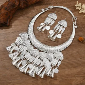 Miao silver ethnic peacock collar necklace and tassel earrings set for tourism and photography.
