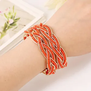 Close-up detail view of multi-strand woven orange beaded bracelet on wrist display.