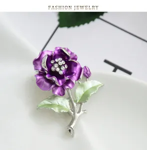 Close-up detail of purple enamel camellia brooch with rhinestones, elegant botanical pin.