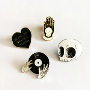 Set of 4 gothic metal enamel pins with skull and heart designs for jackets and bags.