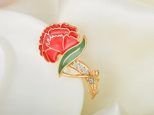 Charming red and green enamel carnation brooch with glittering rhinestones for stylish daily wear.
