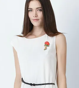 Elegant red carnation brooch detail shot, fashionable metal alloy pin accessory for women.