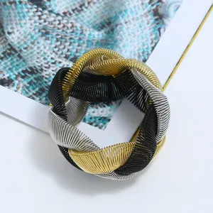 Chunky multi-color metal wire coiled statement bracelet, bold heavy metal design detail.