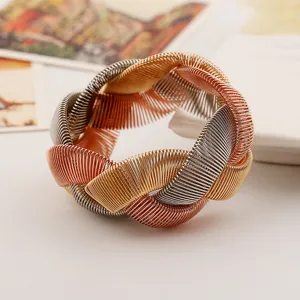 Close-up detail view of the multi-metal spring braided chunky fashion bracelet texture.