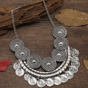 Retro silver coin necklace detail shot, bohemian style alloy statement jewelry close up view.