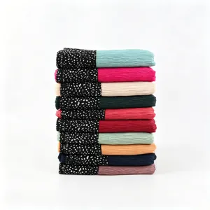 Detailed view of colorful pleated long scarves featuring a chic speckled black pattern border.