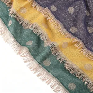 Close-up detail of women rayon metallic jacquard polka dot scarf with short fringe edge.