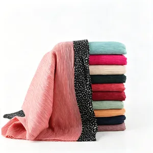 Detailed close-up view of pleated women scarves with printed black border, soft fab.