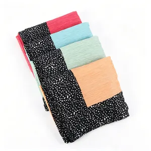 Detailed view of pleated long hijab scarves featuring stylish black dotted contrast borders.