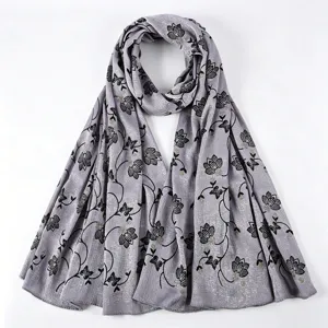 Detailed view of the elegant grey floral long scarf with black leaves and gold glitter accents.