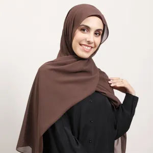 Chiffon hijab detail showcasing soft draped fabric and elegant brown color design for women.