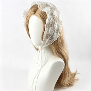 Detail view of white lace triangular headscarf hair accessory, sweet and stylish hair tie.
