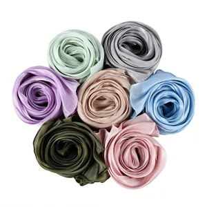 Detailed close-up of colorful crinkle satin long scarves rolled nicely into flower shapes.