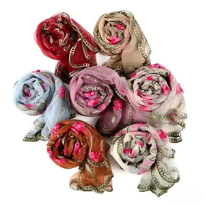Close-up detail showing exquisite floral embroidery and delicate lace edges of lightweight scarves.