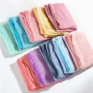 Detailed view of colorful crinkled lace scarves, lightweight honeycomb texture shawls.