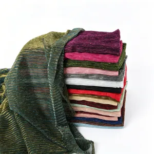 Metallic pleated fabric detail shot showcasing shimmer texture and vibrant color variations.