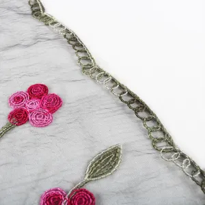 Close-up detail of lightweight nylon embroidered scarf with floral pattern, elegant.