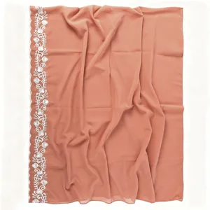 Peach pink chiffon scarf detail featuring delicate white embroidered floral lace border.