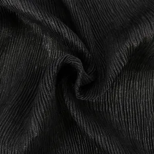 Close-up detail of soft black pleated scarf fabric texture, elegant crinkle design.
